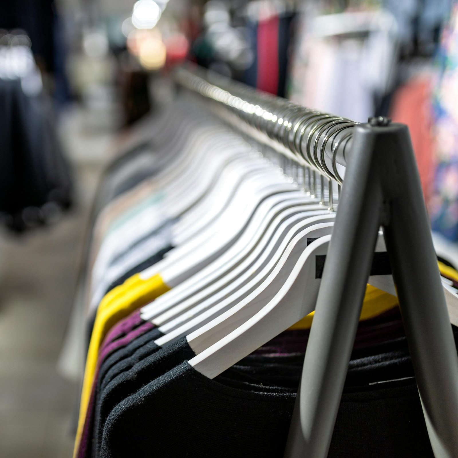 Stylish clothes on hangers in a retail fashion store. Perfect for shopping and lifestyle themes.